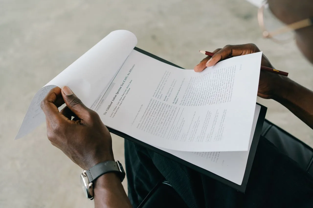 A clinician reviewing a printed autism screening assessment
