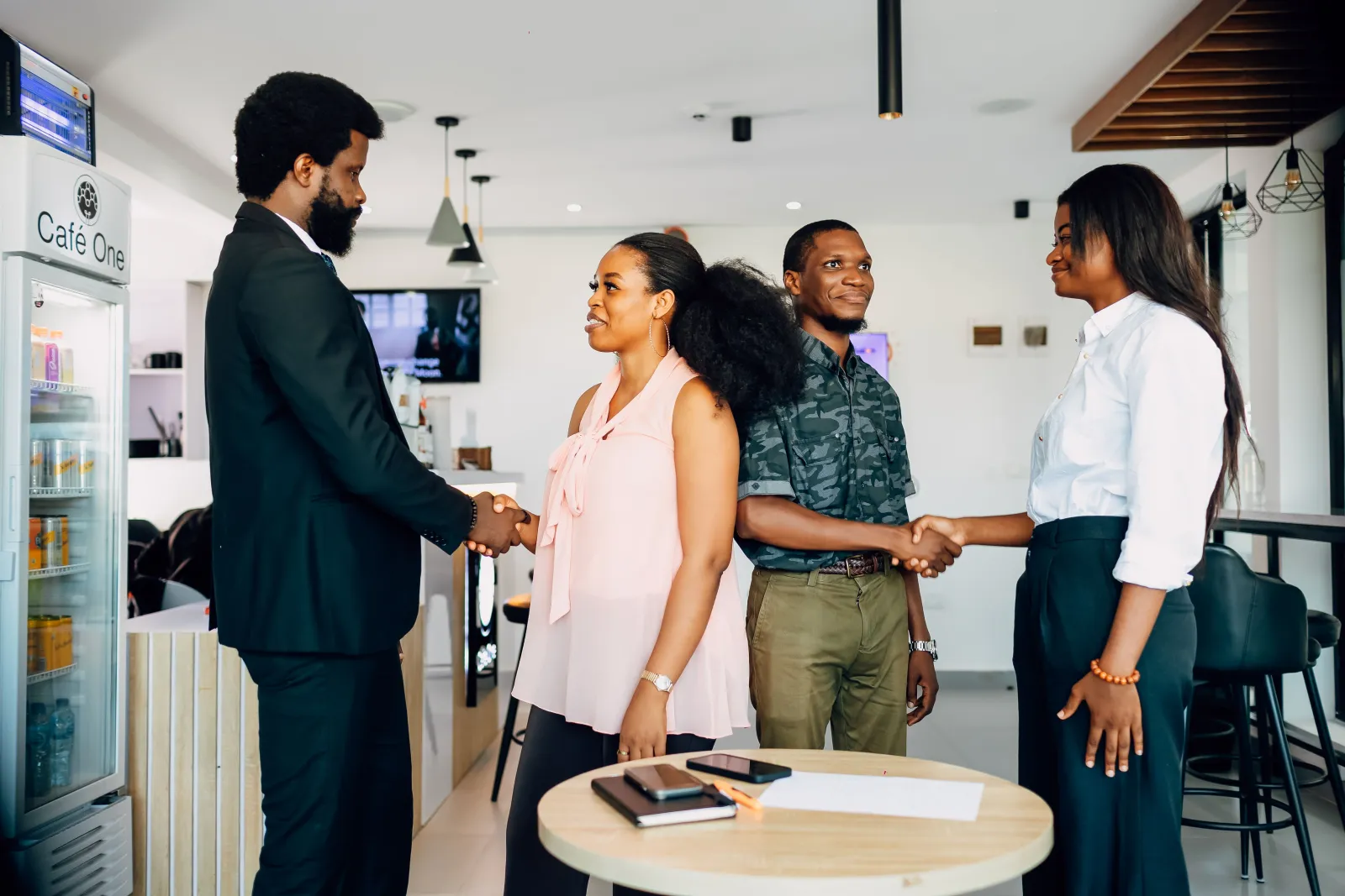 Colleagues shaking hands at the start of a meeting